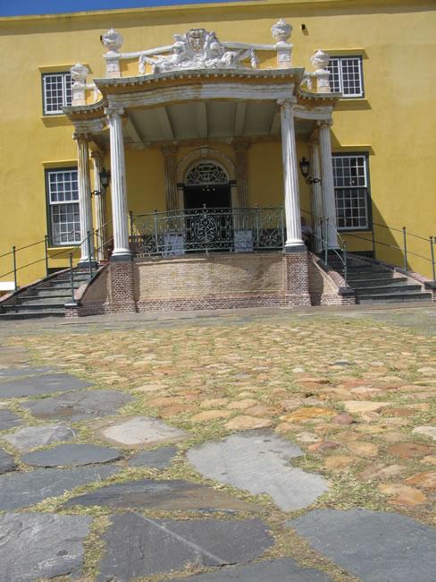 The sculpted Kat Balcony of the Castle of Good Hope above cobbles