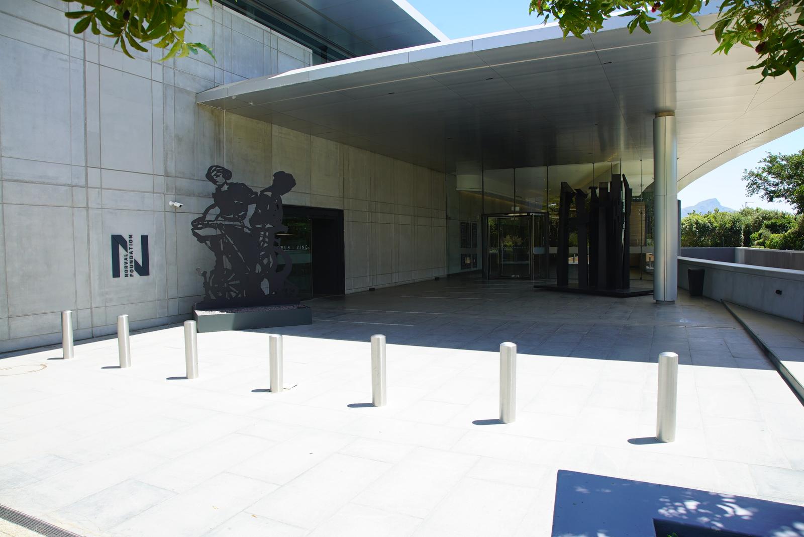 Concrete entrance plaza of the Norval Foundation with cantilevered roof and sculpture